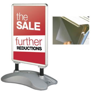 A silver sign with the sale further reductions on it.