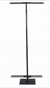 A black pole with a white lamp on top of it.