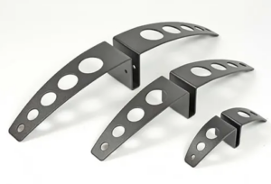 A set of four black metal brackets with holes.