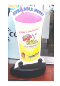 A cup of fruit slush on display outside.