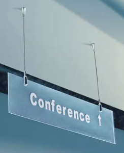 A conference sign hanging from the ceiling.